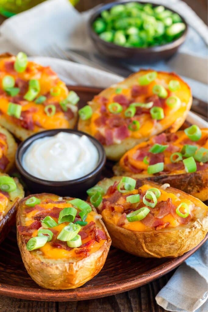 Loaded potato skins topped with melted cheese, crispy bacon, and green onions, served with a side of sour cream. A hearty and crowd-pleasing appetizer that’s perfect for birthday parties, baby showers, or game day snacks.