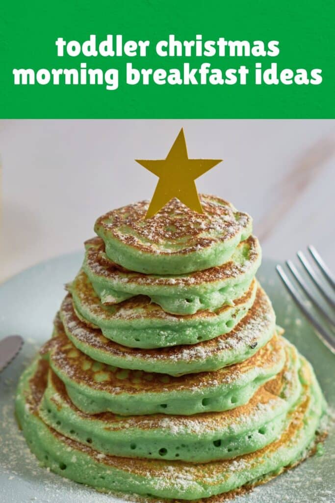 A stack of green pancakes arranged in a Christmas tree shape, dusted with powdered sugar and topped with a yellow paper star. This festive and fun toddler Christmas breakfast idea adds holiday magic to the morning with a sweet and whimsical touch.