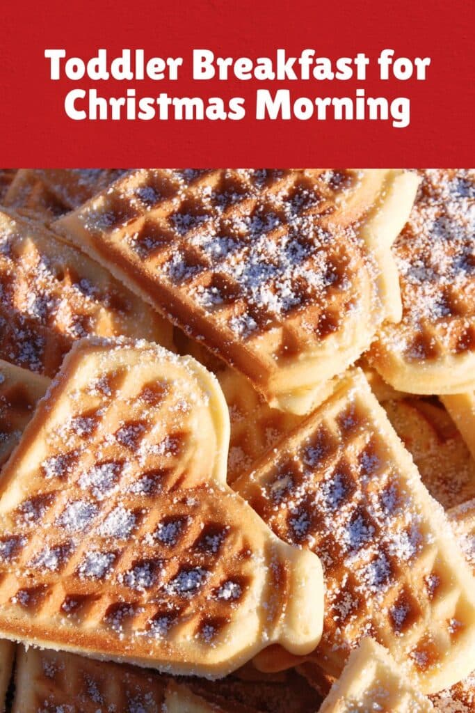 A stack of golden brown heart-shaped waffles dusted with powdered sugar, arranged closely together. This sweet and cozy toddler Christmas breakfast idea is perfect for a festive and comforting holiday morning.