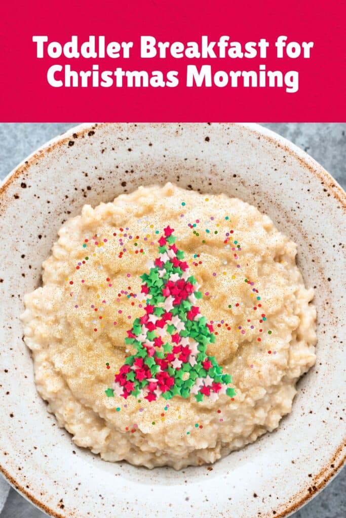 A bowl of oatmeal decorated with colorful holiday sprinkles and topped with a Christmas tree shape made of red, green, and white star-shaped toppings. This festive toddler Christmas breakfast idea adds holiday cheer to a warm and cozy morning meal.
