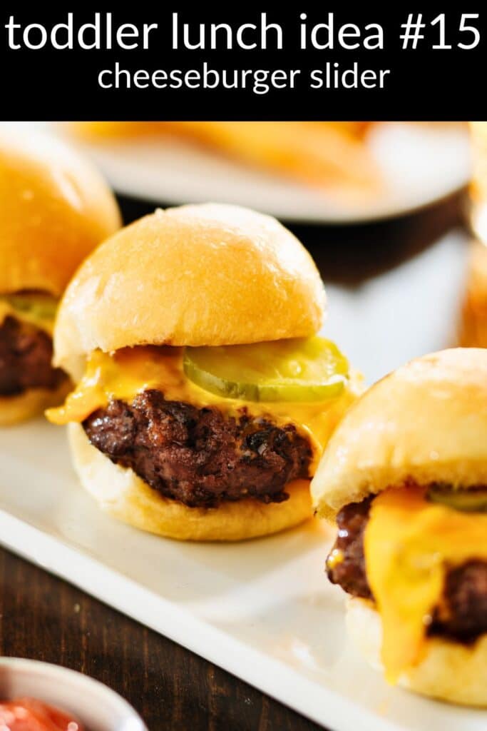 Cheeseburger slider on a soft bun with melted cheese and pickles — an easy toddler lunch idea and kid-friendly protein for daycare bentos.
