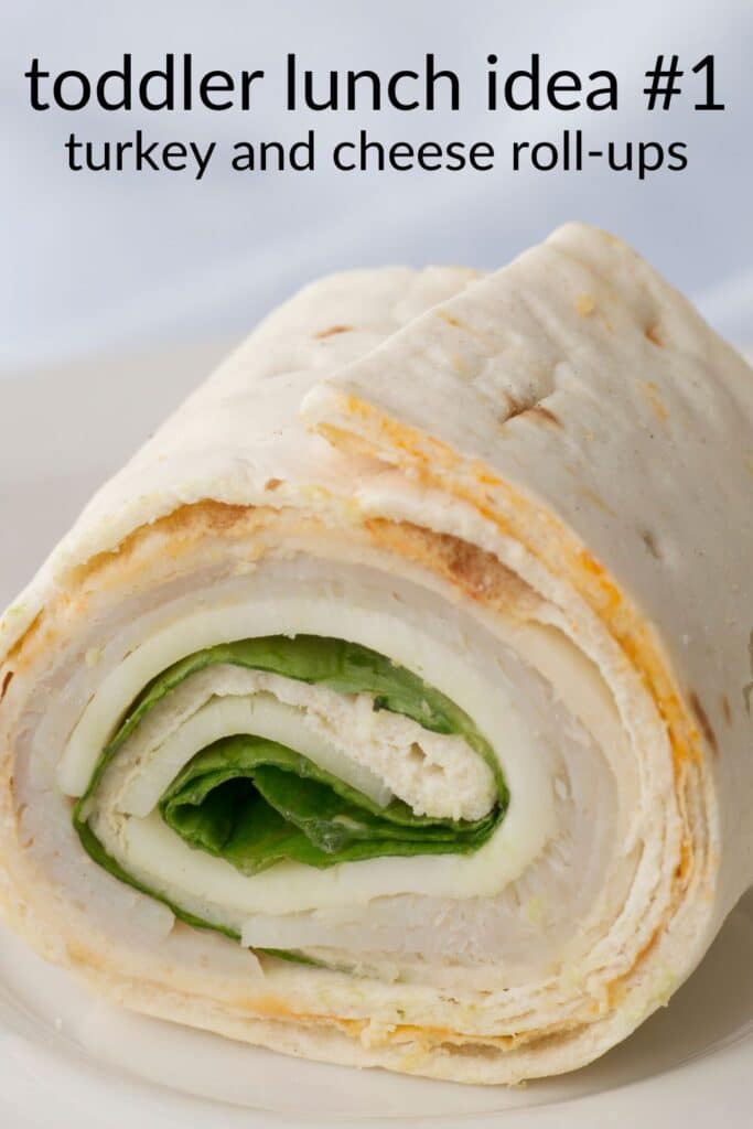 Turkey and cheese roll-ups with lettuce on a soft tortilla — an easy, healthy toddler lunch idea that’s picky-eater friendly and perfect for daycare bentos.