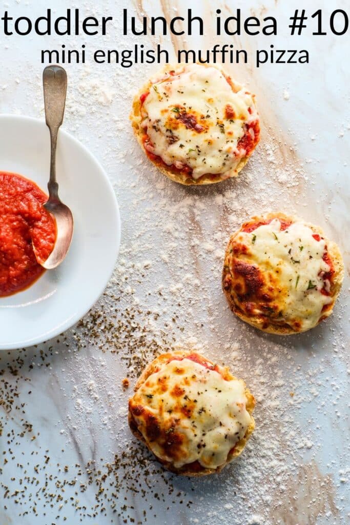 Mini English muffin pizzas with marinara and melted mozzarella — an easy toddler lunch idea and kid-friendly finger food.