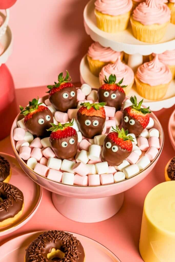 berry first birthday party food idea chocolate covered strawberries and pink dessert table