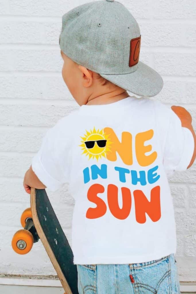 One in the Sun first birthday boy outfit featuring a sunshine graphic t-shirt, perfect for a summer first birthday party, outdoor birthday celebration, and sunshine theme first birthday ideas for boys