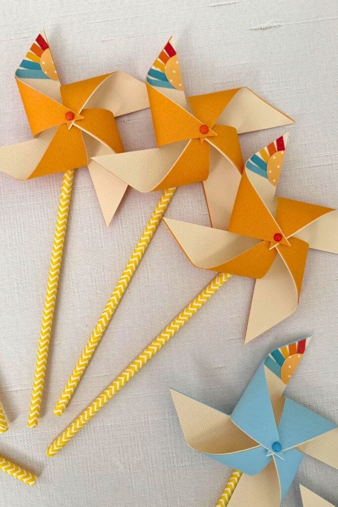 One in the Sun first birthday party favor ideas featuring sunshine pinwheels and yellow striped paper straws, perfect for a summer first birthday party, outdoor birthday celebration, and sunshine theme party ideas for boys
